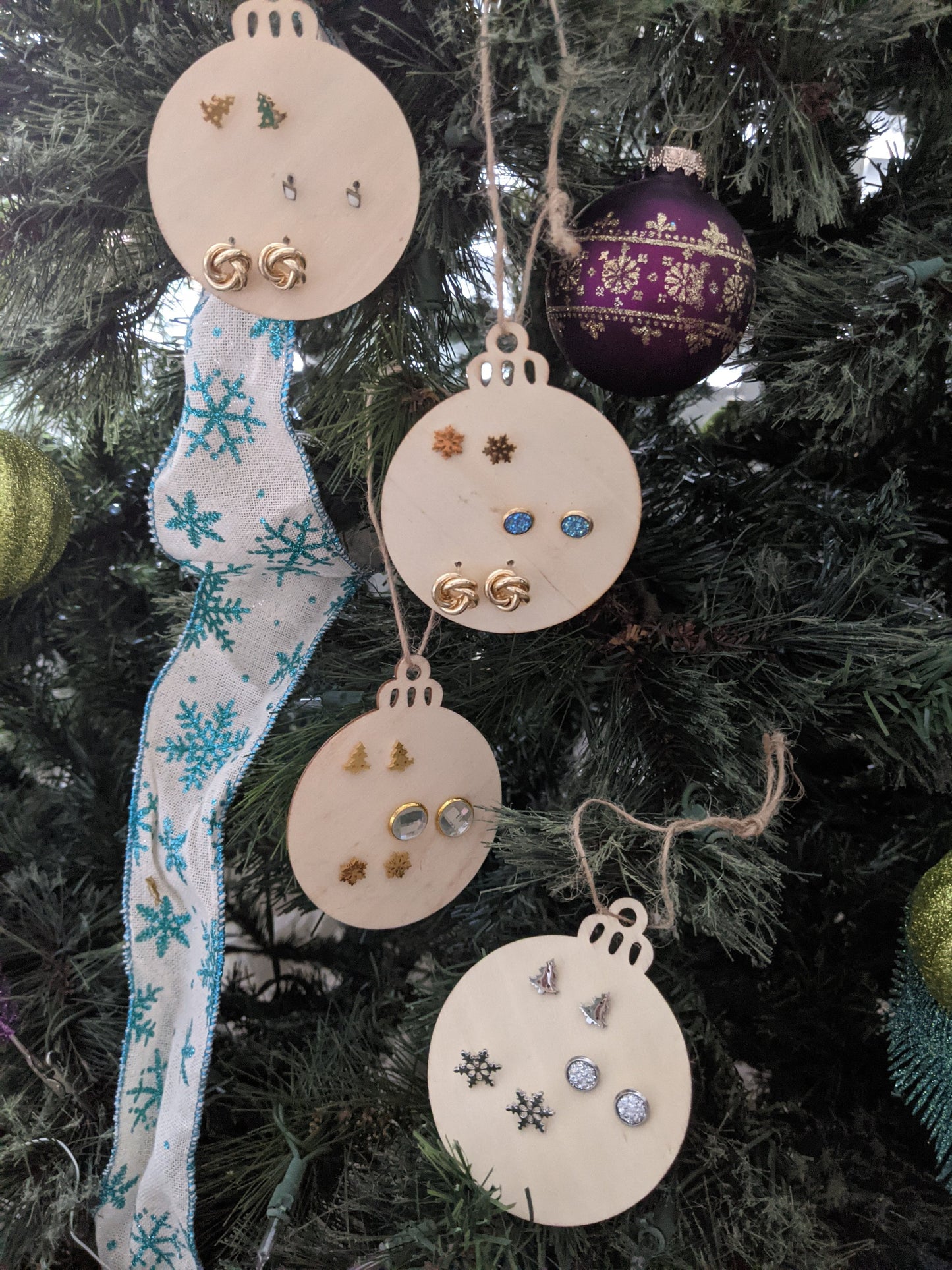 Set of 3 stud earrings on a wooden Christmas ornament
